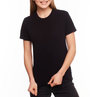 Ön manzara - Reklam ve tişört tasarımı konsepti. Siyah tişört ve siyah kot giyen şık bir kadının, promosyonunuz için fotokopi yeri olan beyaz stüdyo duvarının önünde dikilmiş kesilmiş portresi.