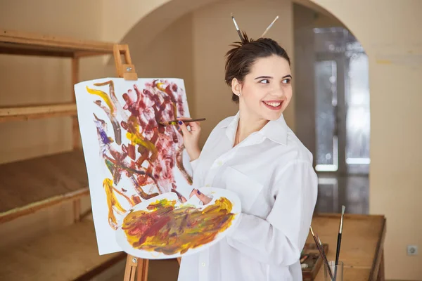 Young Brunette Artist White Shirt Paints Canvas Her Studio Next — стоковое фото