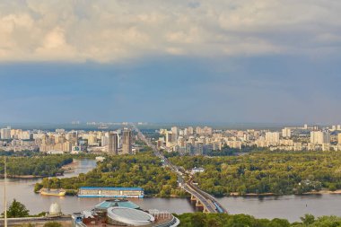 Skyline of Kyiv with Metro bridge and rainbow in the sky. Ukraine