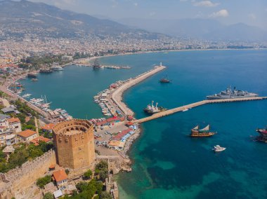 Kizil Kule or Red Tower and port aerial panoramic view in Alanya city, Antalya Province on the southern coast of Turkey. Summer photo taken from a drone