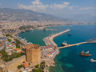 Kizil Kule or Red Tower and port aerial panoramic view in Alanya city, Antalya Province on the southern coast of Turkey. Summer photo taken from a drone