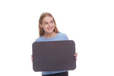 Vivacious young woman winking and laughing as she points at a blank signboard with copy space. isolated on white