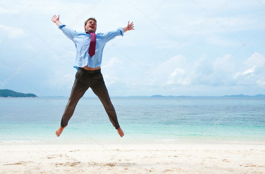 Funny business man jumping on the beach