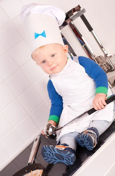 Little baby chef in the cook hat with metal ladle — Stock Photo, Image