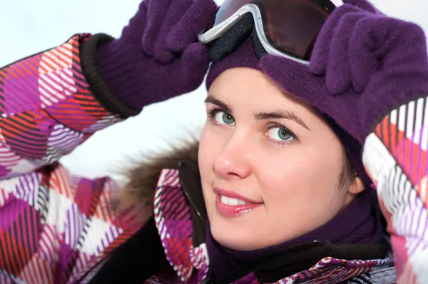 Portrait of smiling happy young woman wearing ski goggles — Stock Photo, Image