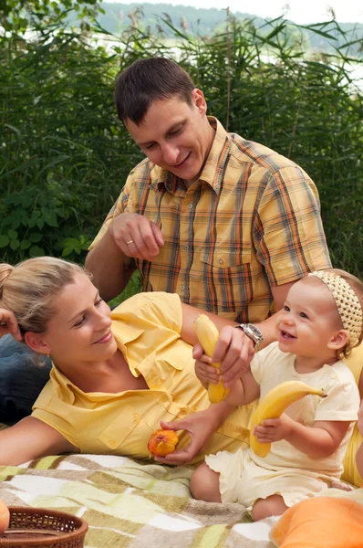 Happy family picnicking outdoors — Stock Photo, Image