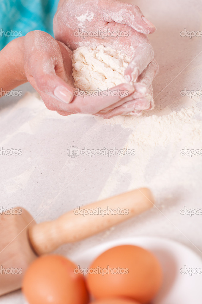 Woman hands preparing dough on the table