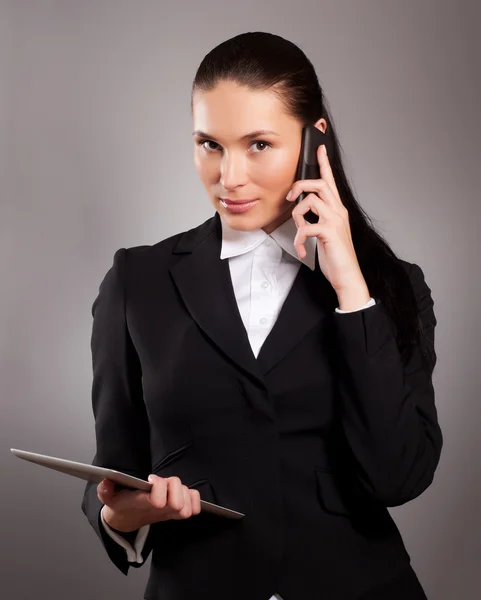 Jeune femme d'affaires parlant au téléphone et utilisant une tablette PC — Photo