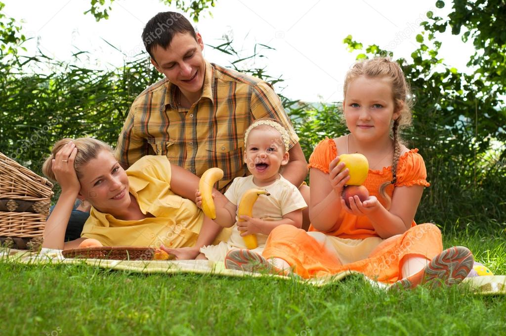 Happy family picnicking outdoors