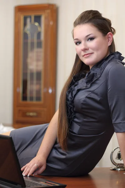 Girl sitting on the desk — Stock Photo, Image