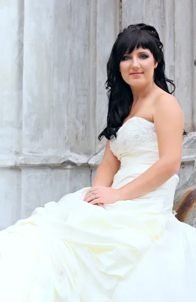 Girl in the wedding dress sitting — Stock Photo, Image