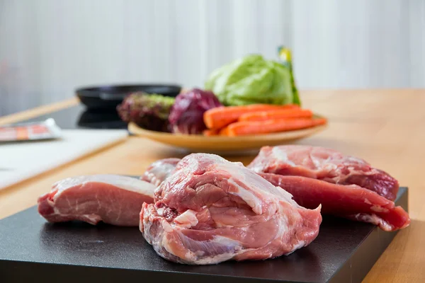 Meat parts with vegetables at background — Stock Photo, Image