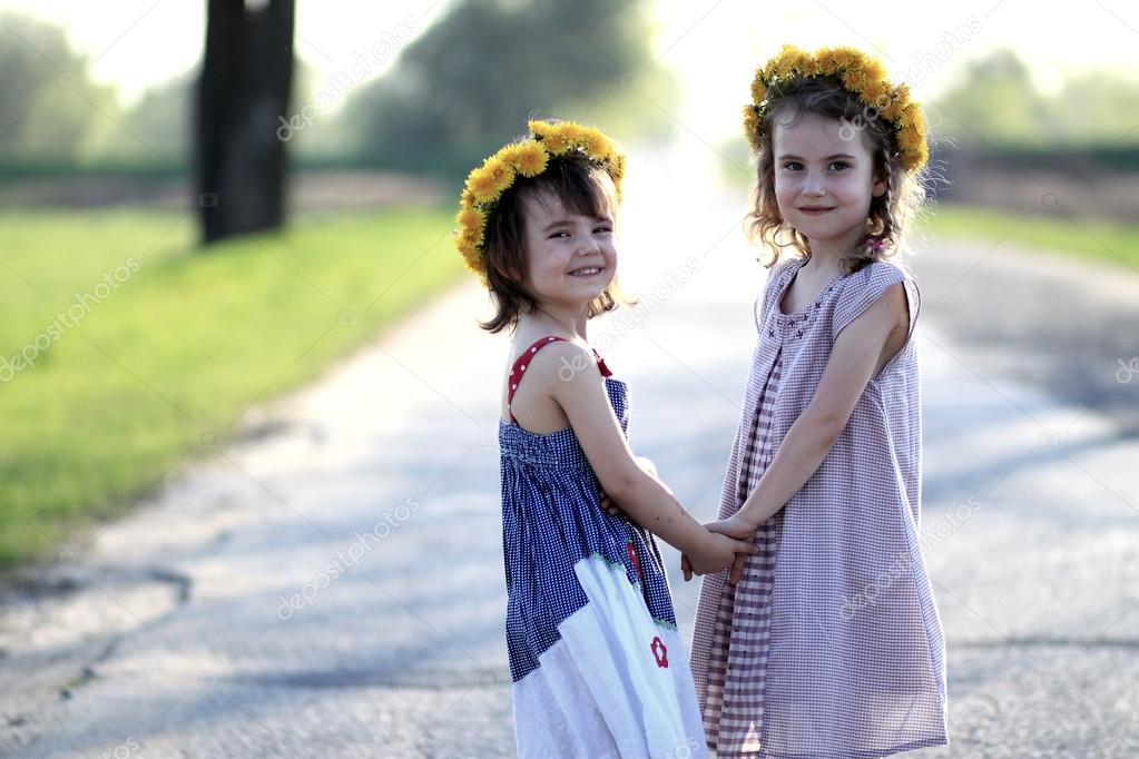 Two girls with garlands