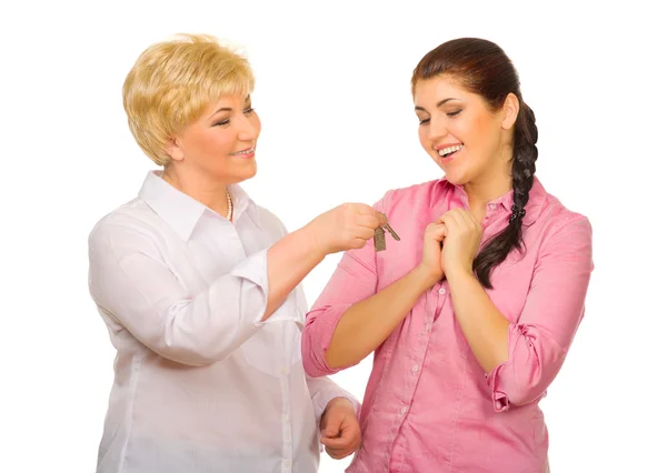 Senior woman giving keys to her daughter — Stock Photo, Image
