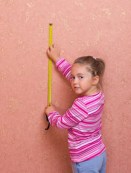 Little girl with measurement tape — Stock Photo, Image