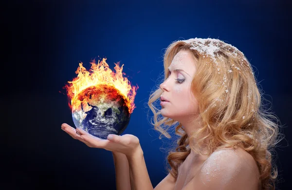 Frozen girl holding burning earth globe — Stock Photo, Image