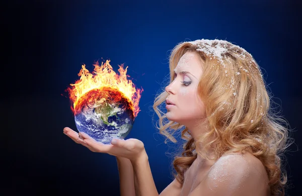 Frozen girl holding burning earth globe — Stock Photo, Image