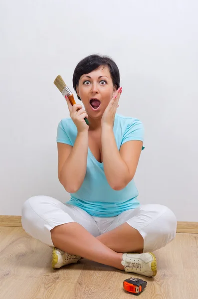 Surprised woman with painting brush — Stock Photo, Image