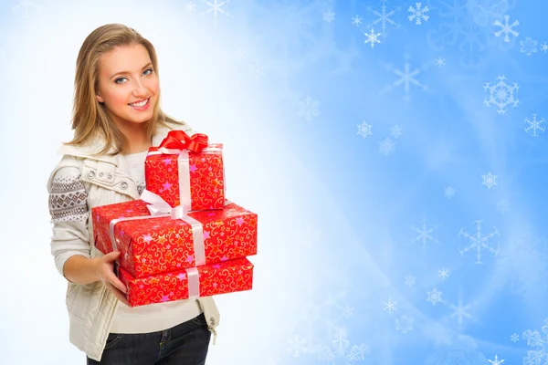Young girl with gift boxes on winter background — Stock Photo, Image