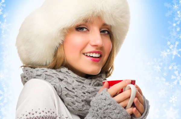 Young girl with mug on winter background — Stock Photo, Image