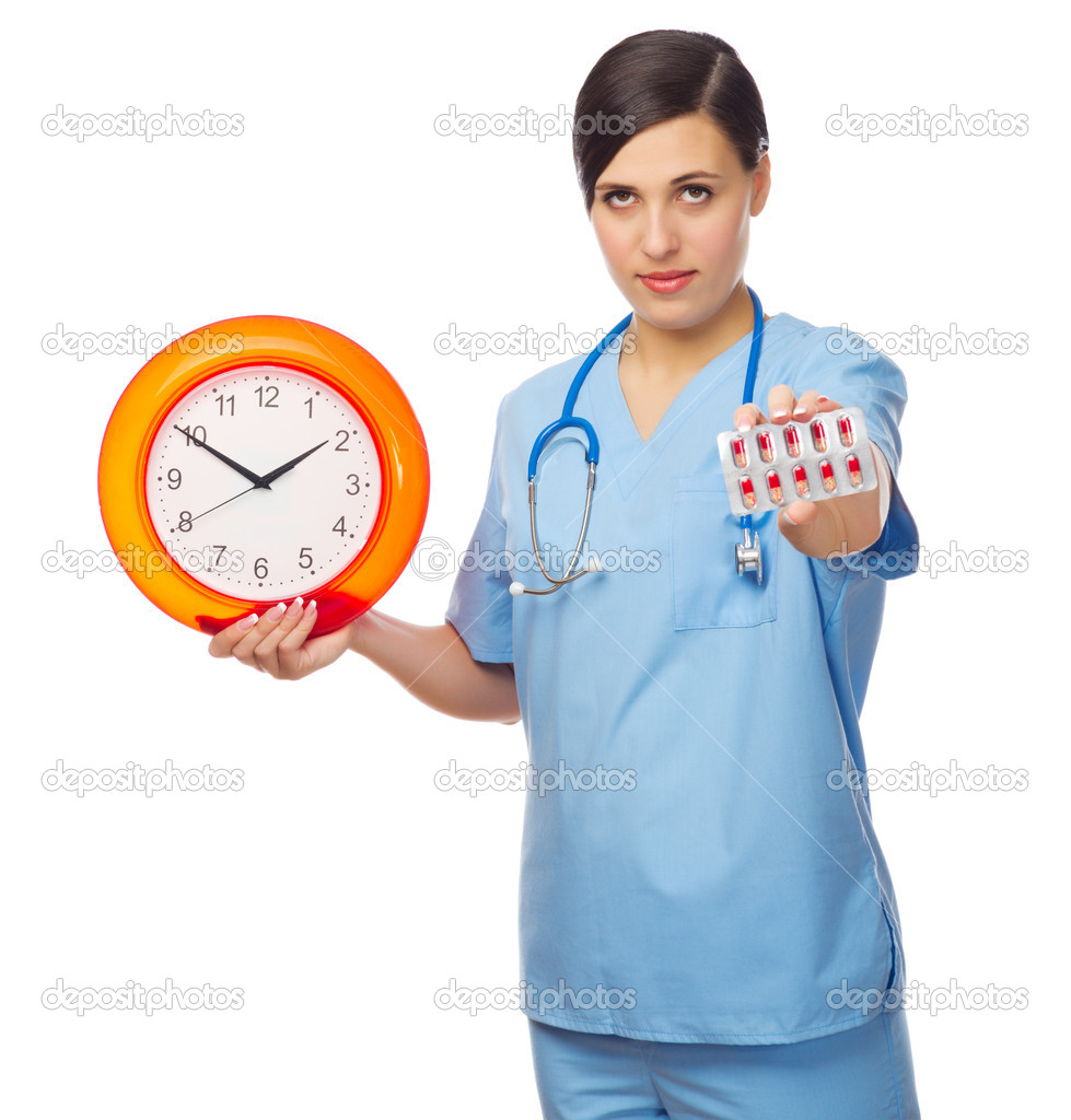 Young doctor showing red pills and clock
