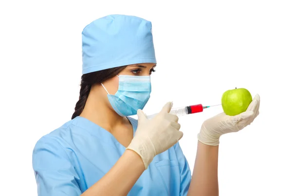 Young doctor with syringe and apple — Stock Photo, Image