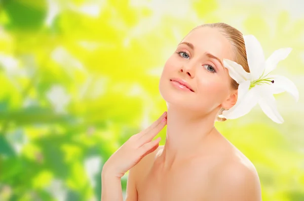 Young healthy girl with flower on spring backgr — Stock Photo, Image