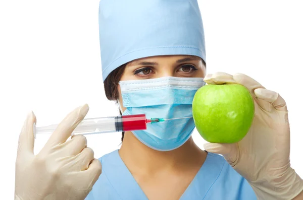 Young doctor with apple and syringe — Stok fotoğraf