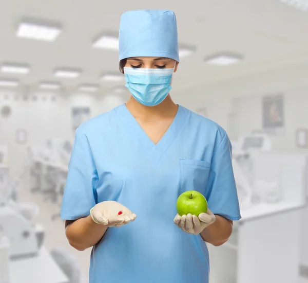 Doctor with pill and apple — Stock Photo, Image