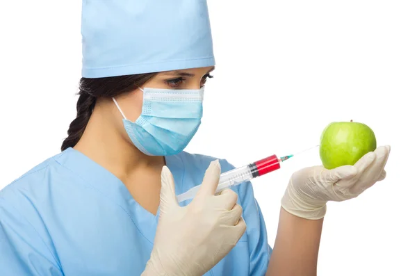 Chemist with syringe and apple — Stock Photo, Image