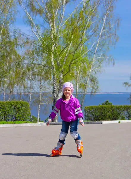 Little girl skating on roller skates — Stock Photo, Image