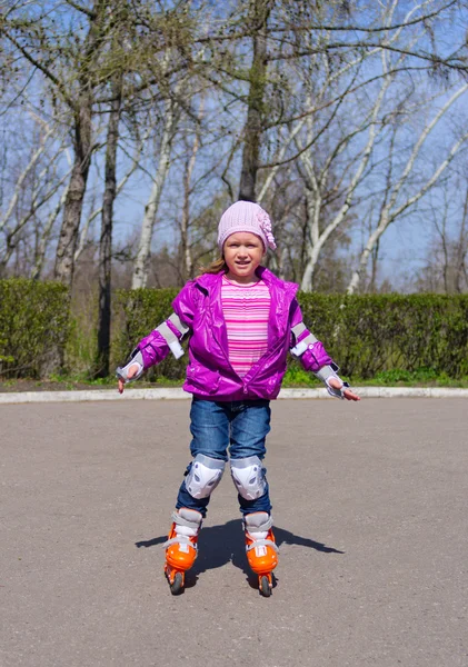 Little girl skating on roller skates — Stock Photo, Image