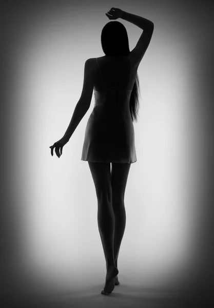 Silhouette of young girl on gray (black and white) — Stock Photo, Image