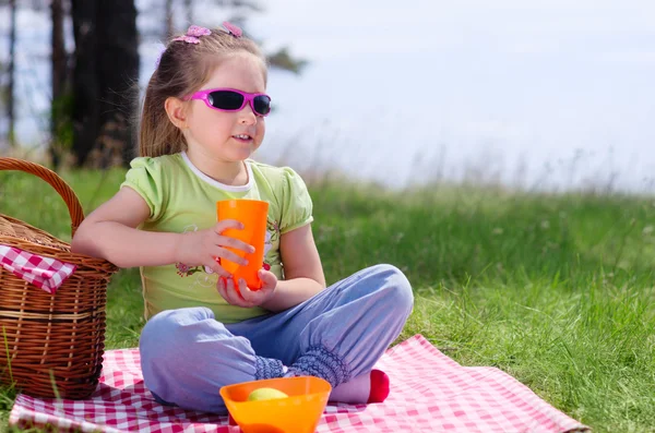 Kislány műanyag pohár és piknik kosár — Stock Fotó