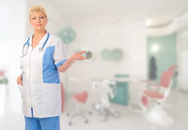 Mature doctor shows welcome gesture — Stock Photo, Image