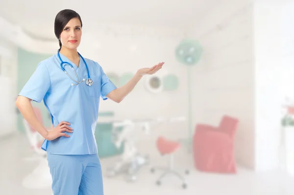 Young doctor shows welcome gesture — Stock Photo, Image