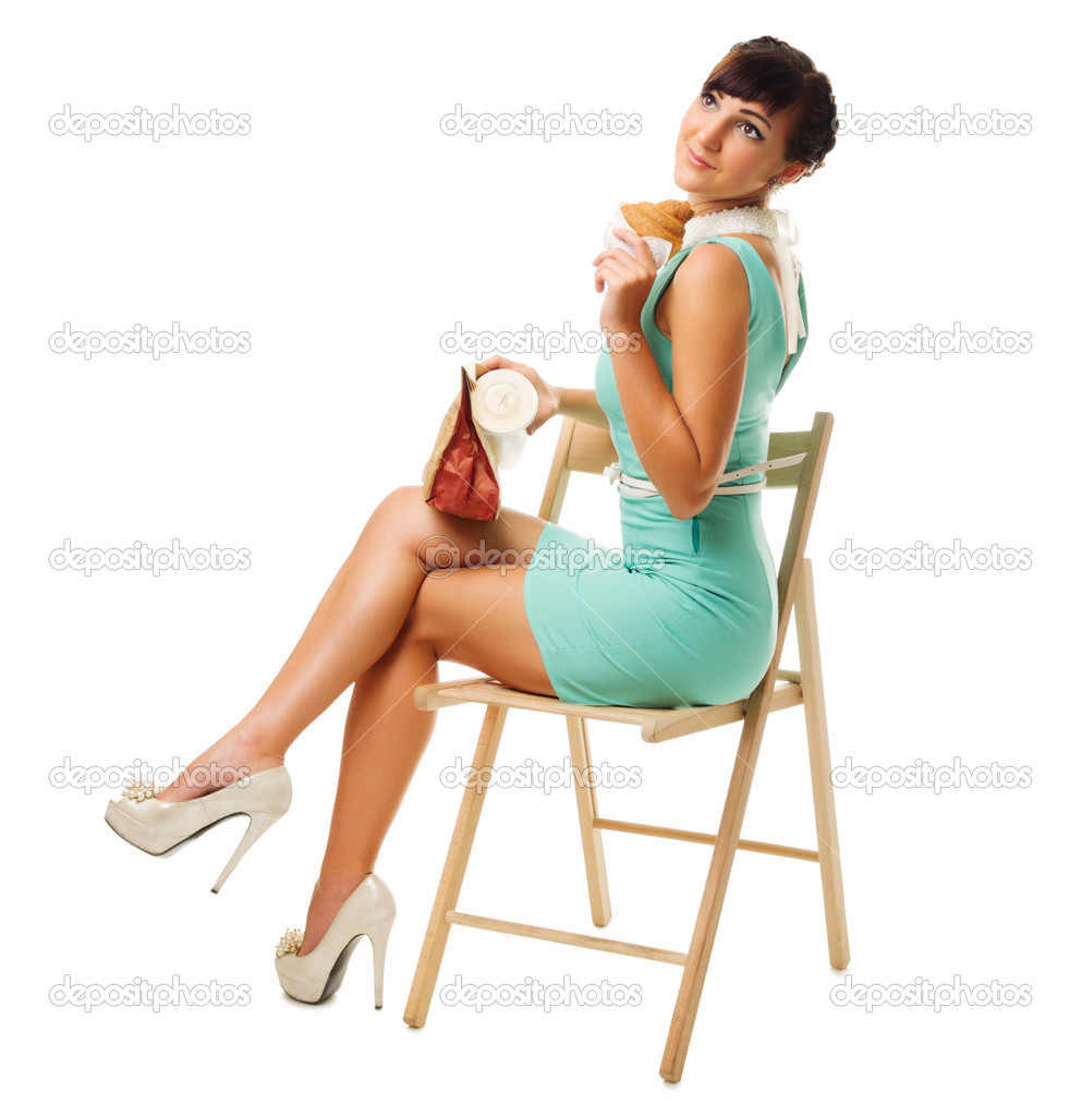 Glamorous girl in turquoise dress holds snacks sit on chair