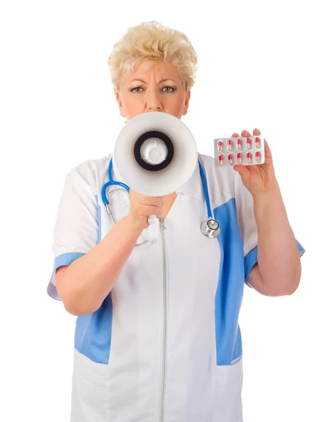 Mature doctor with megaphone and pills — Stock Photo, Image