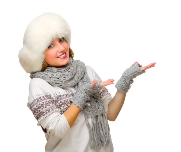 Young girl in fur hat shows welcome gesture — Stock Photo, Image