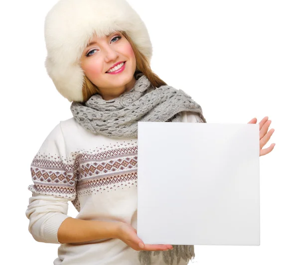 Young girl in fur hat with empty card — Stock Photo, Image
