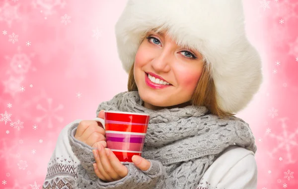 Young girl with mug on winter background — Stock Photo, Image