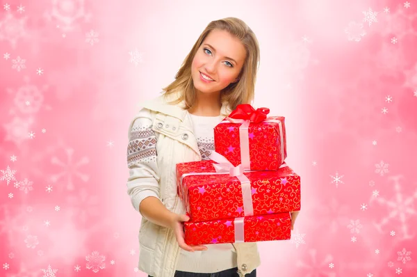 Young girl with gift boxes on winter background — Stock Photo, Image