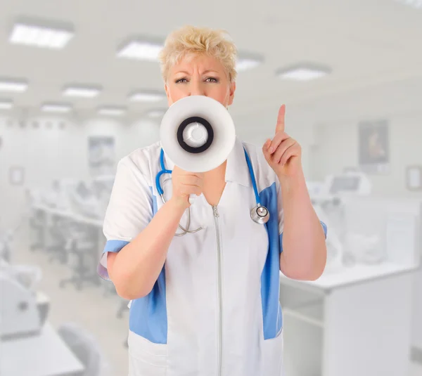 Mature doctor with megaphone — Stock Photo, Image