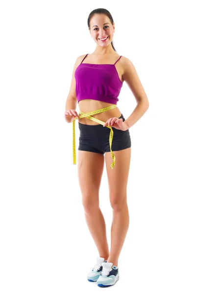 Young sporty girl with centimeter tape — Stock Photo, Image