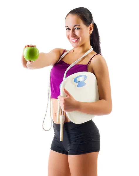 Młoda dziewczyna sportowy z wagi i jabłko — Zdjęcie stockowe