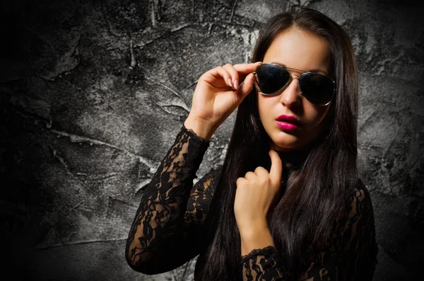 Fashion portrait of young girl on grey wall — Stock Photo, Image