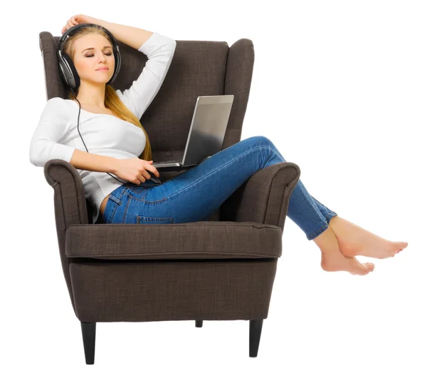 Young girl listen music on chair — Stock Photo, Image