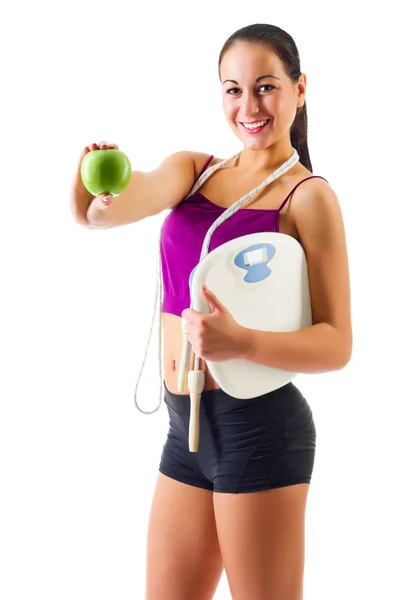 Young sporty woman with apple and scales — Stock Photo, Image