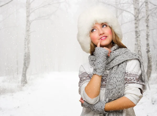 Young woman in fur hat at forest — Stock Photo, Image