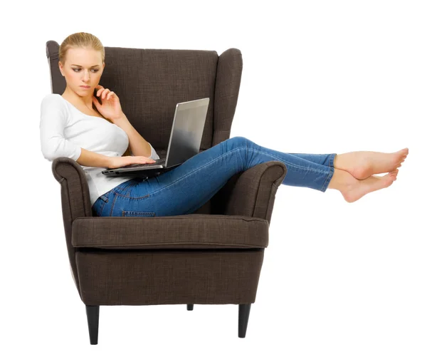 Young girl with laptop on chair — Stock Photo, Image